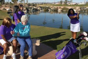 Marilynn Smith shows swing to team captain Booker